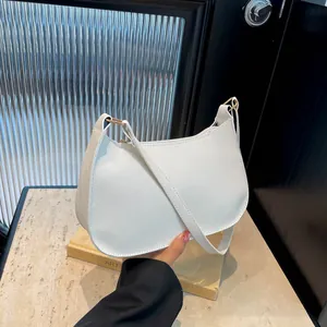 Chic white half-moon baguette bag in premium lychee leather with gold hardware detail