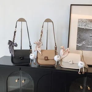 Chic women's shoulder bags with silk scarves and fur charms in black and khaki