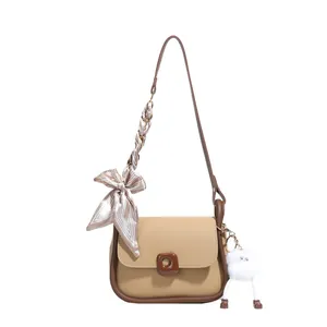 Khaki PU leather shoulder bag with silk scarf strap and plush monster charm decoration
