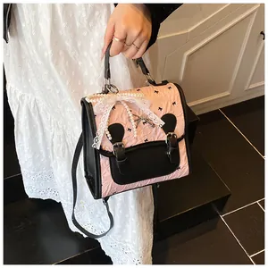 Detail der rosa Rüschen-Tasche mit schwarzen Schleifen, Perlen und Spitzenband