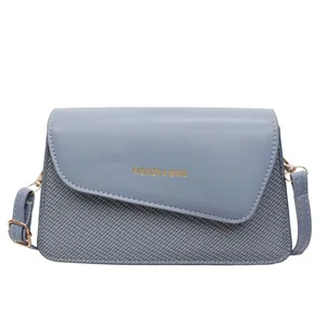 Blue crossbody bag with textured weaving and gold Fashion & Bags lettering logo