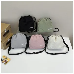 Various colors of nylon drawstring bucket bags with adjustable straps and fashion logo