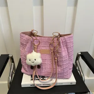 Pink textured tote bag with gold chain strap and cute cloud charm for summer fashion