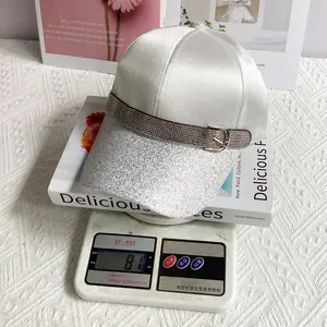 Detail shot of the lightweight 81g stylish rhinestone baseball cap on an electronic scale