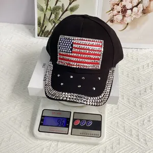 Detail shot of lightweight black baseball cap with rhinestone US flag on electronic scale