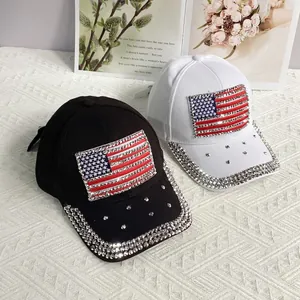 Detailed view of black and white baseball caps with rhinestone American flag and brim