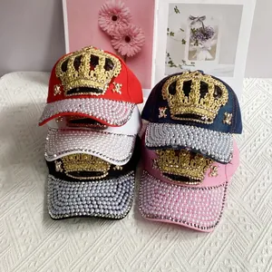Detail of crown embroidery and pearl rhinestones on multi-color baseball caps