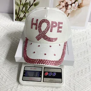 Detailed view of white baseball cap weighing 81g with pink rhinestone HOPE lettering