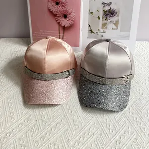 Detail of satin baseball caps with rhinestone buckle and shimmering sequin visors