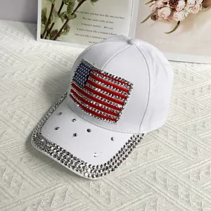 Close-up of sparkling rhinestone US flag patch and glitter brim on white cotton baseball cap