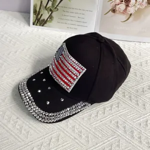 Close-up of sparkling rhinestone American flag patches on a black baseball cap