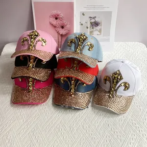 Detail of colorful denim baseball caps with luxury rhinestone fleur-de-lis emblems
