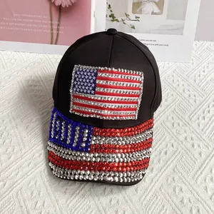 Close-up of black denim baseball cap featuring sparkly rhinestone US flag and USA lettering