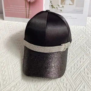 Detailed view of black glitter baseball cap with rhinestone buckle and silky texture