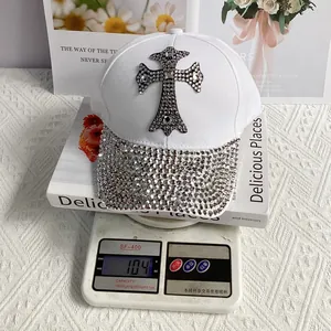 Detailed view of a white baseball cap weighing 104g featuring silver rhinestone crosses