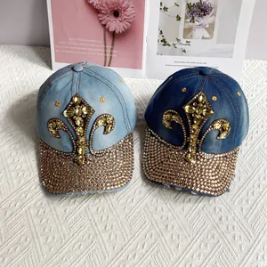 Denim baseball cap with sparkling rhinestone fleur-de-lis pattern and curved brim