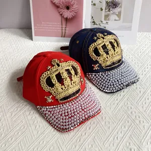 Detail of baseball cap with gold crown embroidery, pearls, and rhinestones