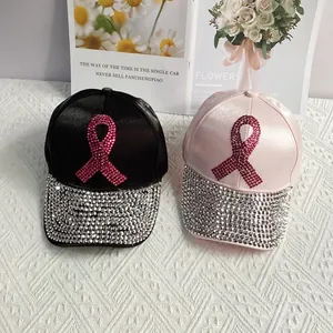 Detailed view of satin baseball caps with rhinestone pink ribbon logo and crystal brim