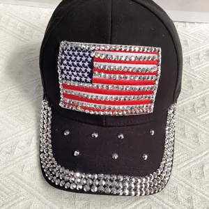 Detail of rhinestone American flag patch and sparkling brim on black baseball cap