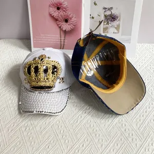 Detail of adjustable leather strap and inner lining of a white denim pearl crown baseball cap