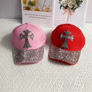 Sparkling rhinestone cross baseball caps in pink and red with crystal studded brims