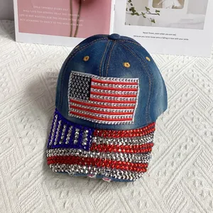 Detailed view of shimmering rhinestone American flag design on a blue denim baseball cap