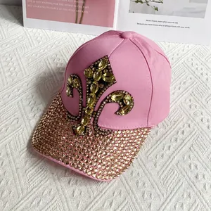 Detailed view of pink denim cap with yellow crystal iris pattern and full rhinestone brim