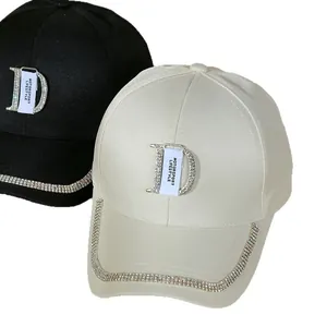 Fashion baseball caps in black and cream with rhinestone trim and metal D logo