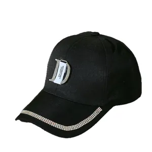 Close-up of black baseball cap with rhinestone letter D and crystal-embellished brim detail