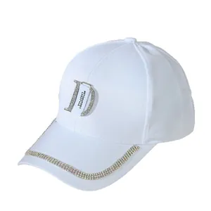 White baseball cap with rhinestone letter D and crystal trim on brim in cotton canvas