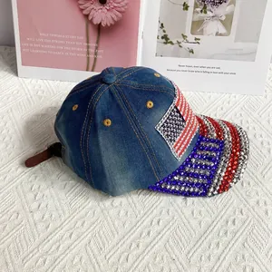 Close-up of denim baseball cap with American flag rhinestone pattern and embroidery
