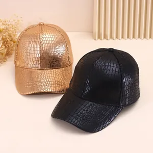 Gold and black faux leather baseball caps with crocodile texture in a premium studio setting