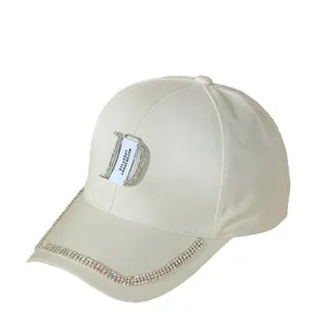 Detail of cream baseball cap featuring rhinestone 'D' logo and motorsport lifestyle tag