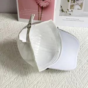 Detail view of white baseball cap interior with silver metal buckle and soft fabric texture