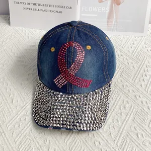 Detailed shot of denim baseball cap with pink rhinestone ribbon and sparkling brim