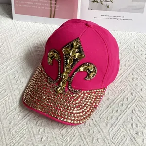 Detail of rose pink denim baseball cap with gold rhinestones and fleur-de-lis pattern