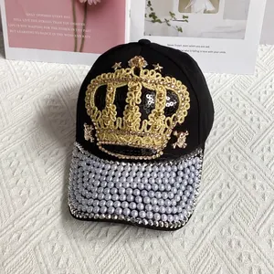 Detail of crown embroidery, sequins and pearls on a black heavy-duty baseball cap