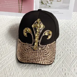 Detailed view of black denim baseball cap with fleur-de-lis crystal and rhinestone brim