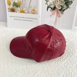 Close-up of burgundy crocodile pattern faux leather on a stylish windproof baseball cap