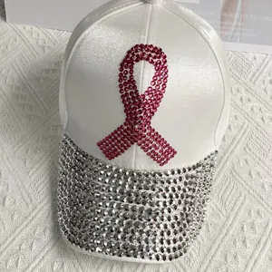 Detail of white satin baseball cap with pink rhinestone ribbon and silver studded brim