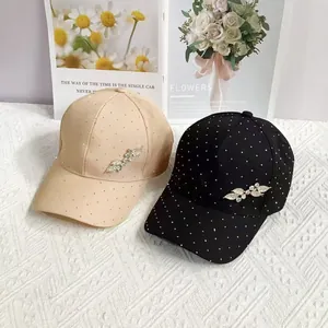 Black and beige baseball caps with rhinestone leaf brooch and sparkling stone patterns