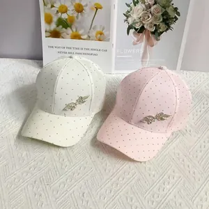 Luxe rhinestone leaf baseball caps in white and pink with elegant metal accents