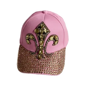 Pink denim baseball cap featuring gold rhinestone fleur-de-lis and studded brim