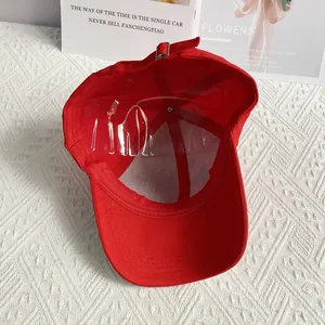 Interior view of red cotton baseball cap with six-panel structure and metal adjustment buckle