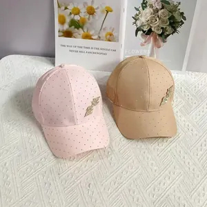 Detail of pink and khaki baseball caps with small rhinestones and metal leaf ornaments