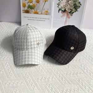 Houndstooth baseball cap with diamond-studded M logo in black and white styles