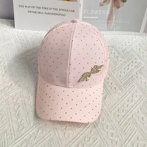 Detailed view of light pink baseball cap with sparkling leaf rhinestones and crystals