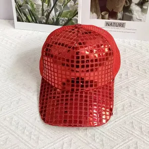 Detail of red sequined baseball cap with breathable mesh back on white texture background