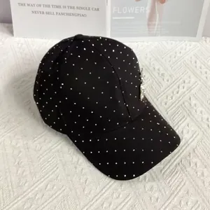 Detailed macro view of black baseball cap with silver rhinestones and 3D floral accents
