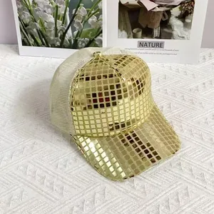 Close-up of golden sequins on baseball cap with reflective mirror finish and mesh